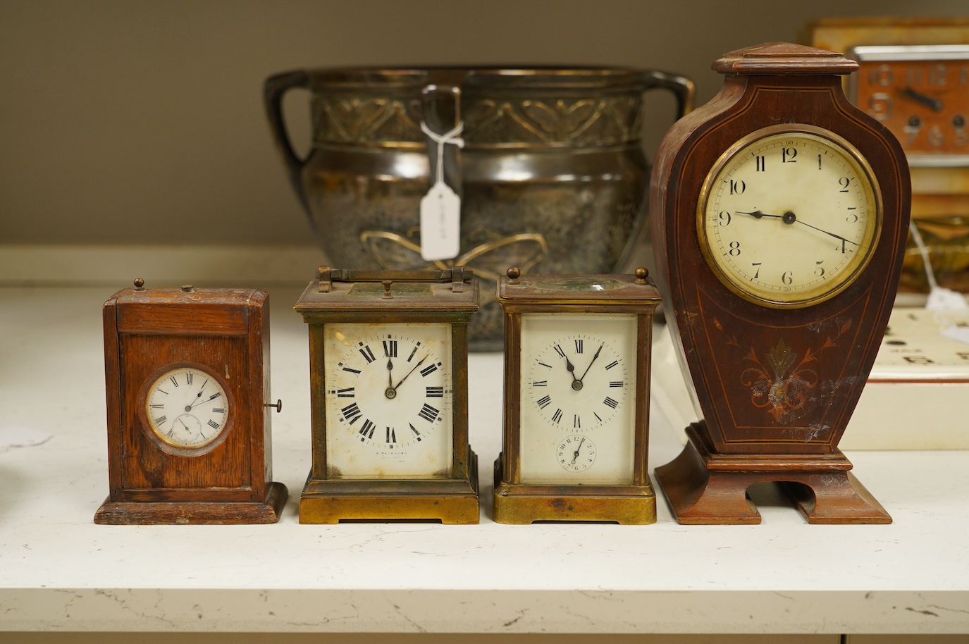 Two carriage clock, an Edwardian mantel clock, 25cm high, and a watch mounted in an oak case (4). Condition - fair, not tested for working